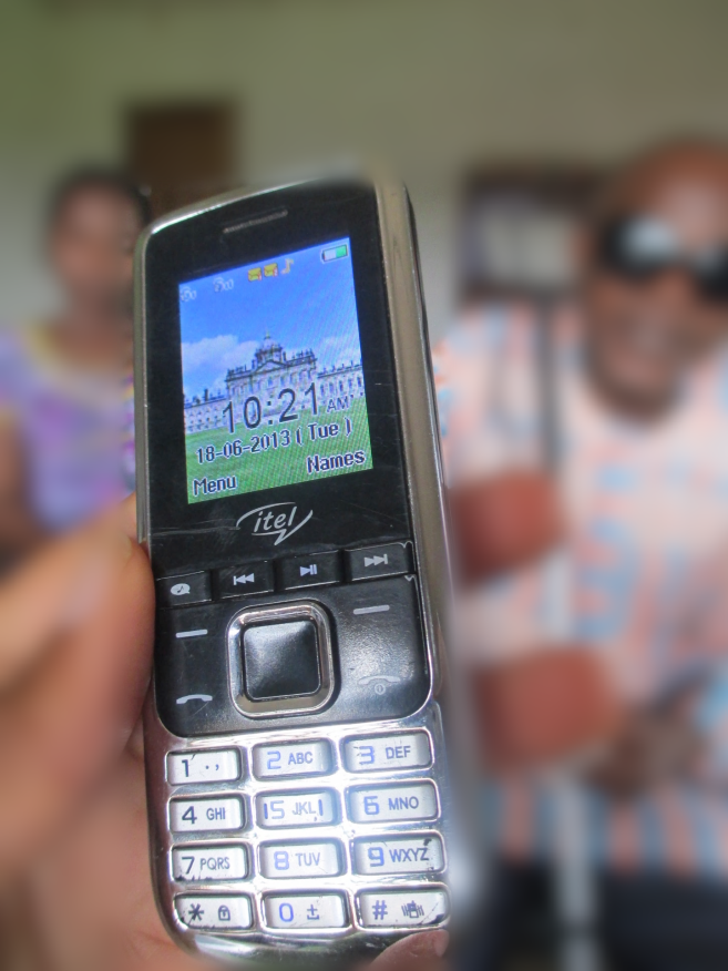 Image of mobile phone held by a blind man